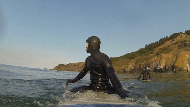 surfer positioning themselves on surfboard