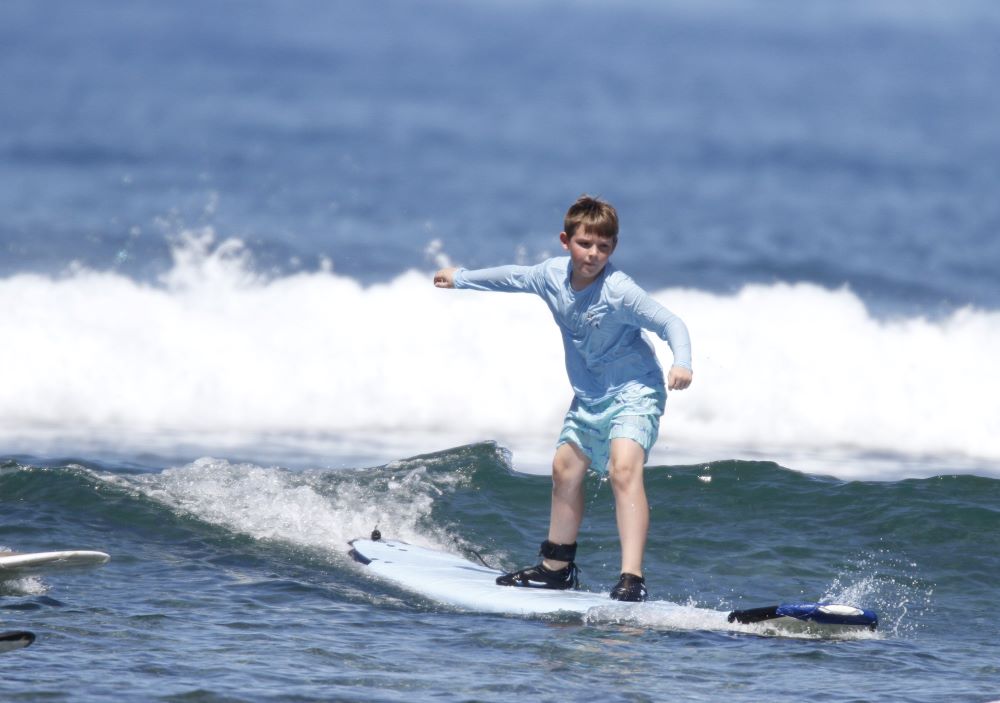 kid surfing longboard